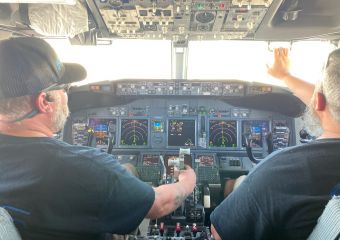 Technicians inspect airplane cockpit